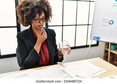 Young African American Woman Taking Pill At Office