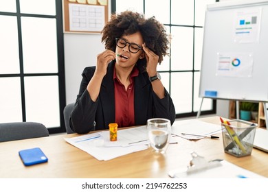 Young African American Woman Taking Pill At Office