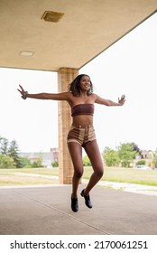 Young African American Woman Tap Dancing Outside