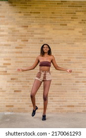 Young African American Woman Tap Dancing Outside