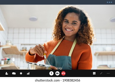 Young African American Woman Teaching Cooking Online Via Video Call In Kitchen At Home