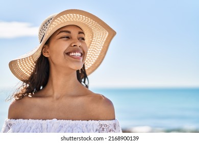 Young african american woman tourist smiling confident wearing summer hat at seaside - Shutterstock ID 2168900139