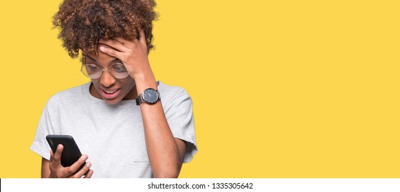 Young african american woman using smartphone over isolated background stressed with hand on head, shocked with shame and surprise face, angry and frustrated. Fear and upset for mistake.