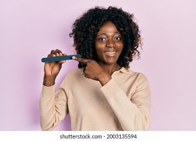 Young African American Woman Using File Nail Smiling Happy Pointing With Hand And Finger 