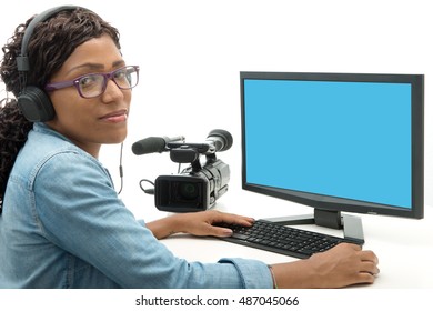 Young African American Woman Video Editor With Computer And Camcorder