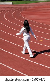 Young African American Woman Walking For Exercise On Outdoor Track