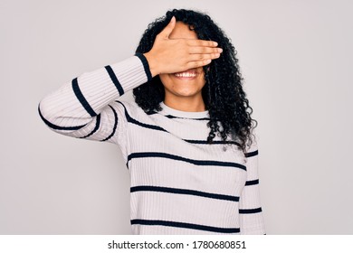 Young African American Woman Wearing Striped Sweater And Glasses Over White Background Smiling And Laughing With Hand On Face Covering Eyes For Surprise. Blind Concept.