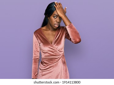 Young African American Woman Wearing Sexy Party Dress Surprised With Hand On Head For Mistake, Remember Error. Forgot, Bad Memory Concept. 