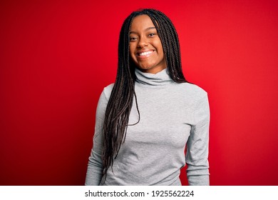 Young African American Woman Wearing Turtleneck Sweater Over Red Isolated Background With A Happy And Cool Smile On Face. Lucky Person.