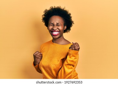 Young African American Woman Wearing Casual Clothes Celebrating Surprised And Amazed For Success With Arms Raised And Eyes Closed. Winner Concept. 