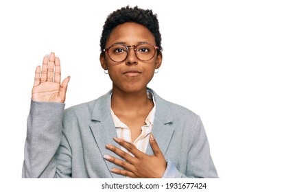 Young African American Woman Wearing Business Clothes Swearing With Hand On Chest And Open Palm, Making A Loyalty Promise Oath 