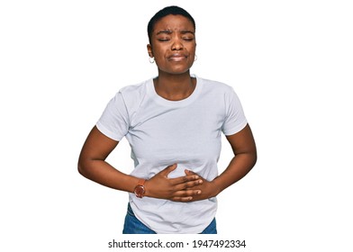 Young African American Woman Wearing Casual White T Shirt With Hand On Stomach Because Indigestion, Painful Illness Feeling Unwell. Ache Concept. 