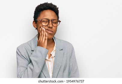 Young african american woman wearing business clothes touching mouth with hand with painful expression because of toothache or dental illness on teeth. dentist 