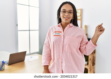 Young African American Woman Wearing Hello My Name Is Sticker Identification Smiling Happy Pointing With Hand And Finger To The Side 
