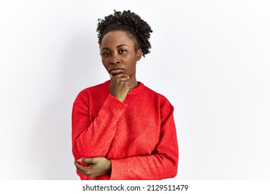 Young African American Woman Wearing Casual Clothes Over Isolated Background Looking Confident At The Camera With Smile With Crossed Arms And Hand Raised On Chin. Thinking Positive. 