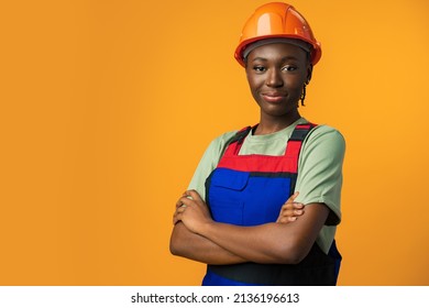 Young african american woman wearing architect hardhat against yellow background - Shutterstock ID 2136196613