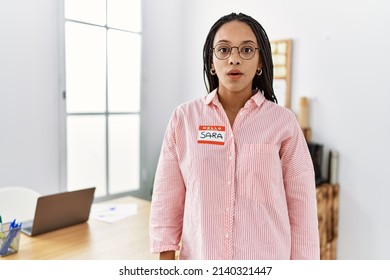 Young African American Woman Wearing Hello My Name Is Sticker Identification Scared And Amazed With Open Mouth For Surprise, Disbelief Face 
