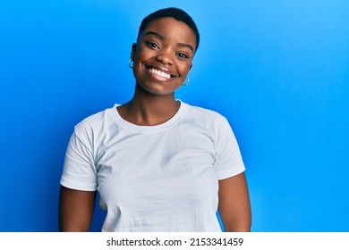 Young african american woman wearing casual white t shirt with a happy and cool smile on face. lucky person.  - Powered by Shutterstock