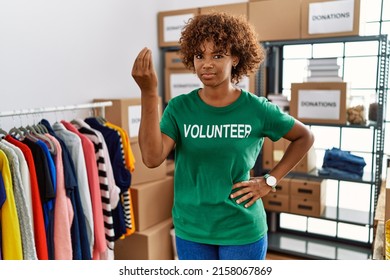 Young African American Woman Wearing Volunteer T Shirt At Donations Stand Doing Italian Gesture With Hand And Fingers Confident Expression 