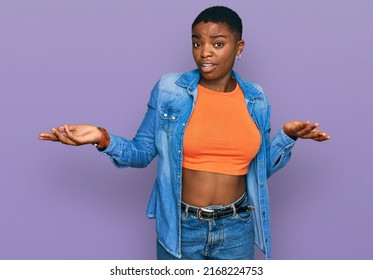 Young African American Woman Wearing Casual Clothes Clueless And Confused With Open Arms, No Idea Concept. 