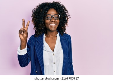 Young African American Woman Wearing Business Clothes And Glasses Smiling Looking To The Camera Showing Fingers Doing Victory Sign. Number Two. 