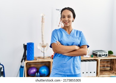 Young african american woman wearing physio therapist uniform standing with arms crossed gesture at clinic - Shutterstock ID 2173855305