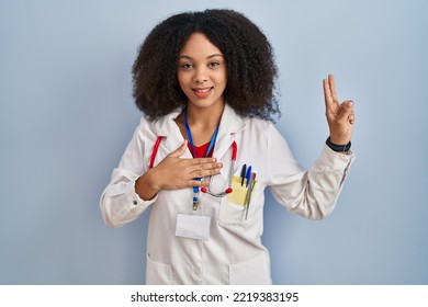 Young African American Woman Wearing Doctor Uniform And Stethoscope Smiling Swearing With Hand On Chest And Fingers Up, Making A Loyalty Promise Oath 