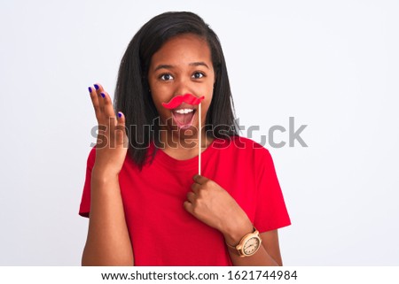 Young african american woman wearing vintage pretend mustache over isolated background very happy and excited, winner expression celebrating victory screaming with big smile and raised hands