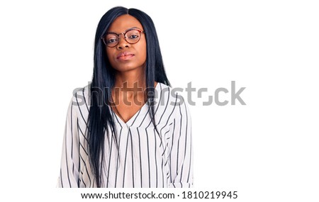 Young african american woman wearing casual clothes and glasses looking sleepy and tired, exhausted for fatigue and hangover, lazy eyes in the morning. 