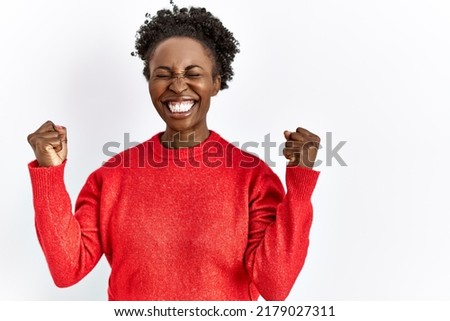 Young african american woman wearing casual clothes over isolated background excited for success with arms raised and eyes closed celebrating victory smiling. winner concept. 