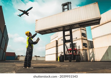 Young African American woman worker at overseas shipping container yard . Logistics supply chain management and international goods export concept . - Powered by Shutterstock