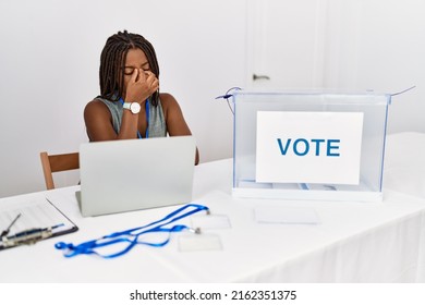 Young African American Woman Working At Political Election Sitting By Ballot Tired Rubbing Nose And Eyes Feeling Fatigue And Headache. Stress And Frustration Concept. 