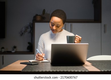 Young African American woman working late from home