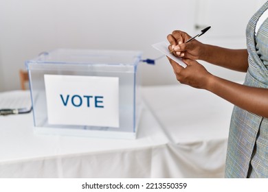 Young African American Woman Writing Vote At Electoral College