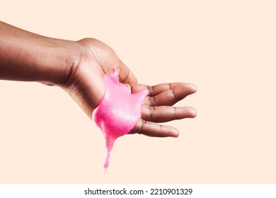 Young African American Woman's Hand Dripping With Pink Body Scrub, Sugar Scrub For Showering Body Polish