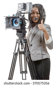 A Young African American Women With Professional Video Camera And Headphone