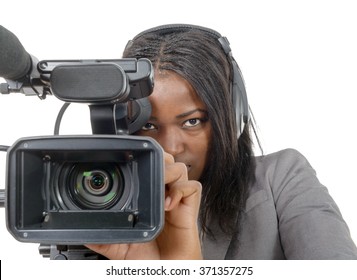 A Young African American Women With Professional Video Camera And Headphone