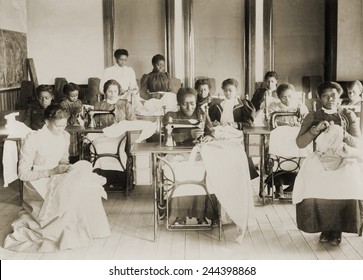 Young African American women sewing with machines and by hand in the sewing class at the Agricultural and Mechanical College, Greensboro, N.C. - Powered by Shutterstock