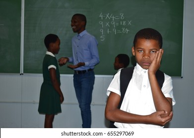 Young African Black Boy Looking Sad In Class Wearing Uniform