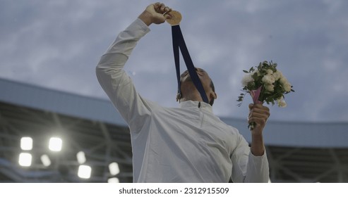 Young African Black male Athlete Celebrates a Win on a podium, receives a gold medal - Powered by Shutterstock