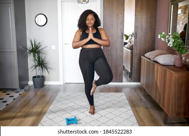 young african black woman keep balance, stand on one leg, yoga time at home. concentrated on yoga, meditation - Shutterstock ID 1845522283