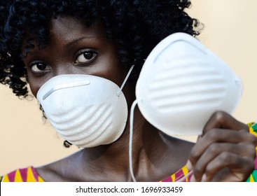 Young African Black Woman Wearing Medical Prevention Face Mask Wearing Traditional Clothing - Powered by Shutterstock