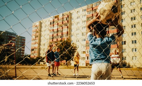 Young African Boy Throwing the Ball from Offline, Neighborhood Kids Starting to Play Soccer in the Hood. Multicultural Friends Play Football Together in the Suburbs. Footage Through a Fence. - Shutterstock ID 2236052653