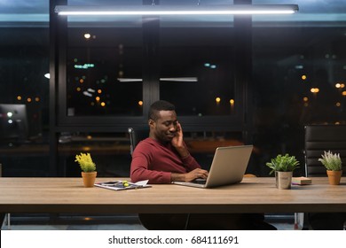 Young African Businessman Spending Time At His Office During The Night. Concept Of Doing Overtime.