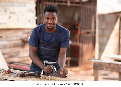 young african carpenter smiling while working