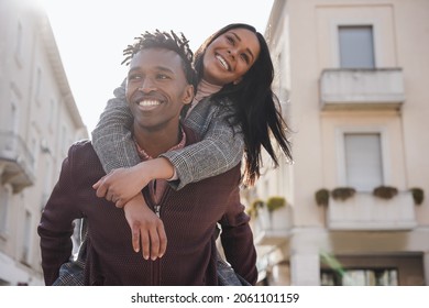 Young african couple having fun walking around the city - Focus on man face - Powered by Shutterstock