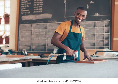 Young African Craftsman Working In A Picture Framing Workshop