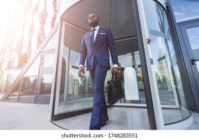Young African Entrepreneur Man Leaving Business Center Building After Work. Business People And Successful Career Concept