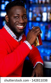 Young African Guy Drinking Beer In Nightclub