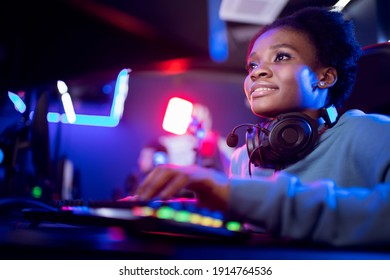 Young African Happy Woman Professional Gamer Win In Online Video Game With Headphones, Neon Background.